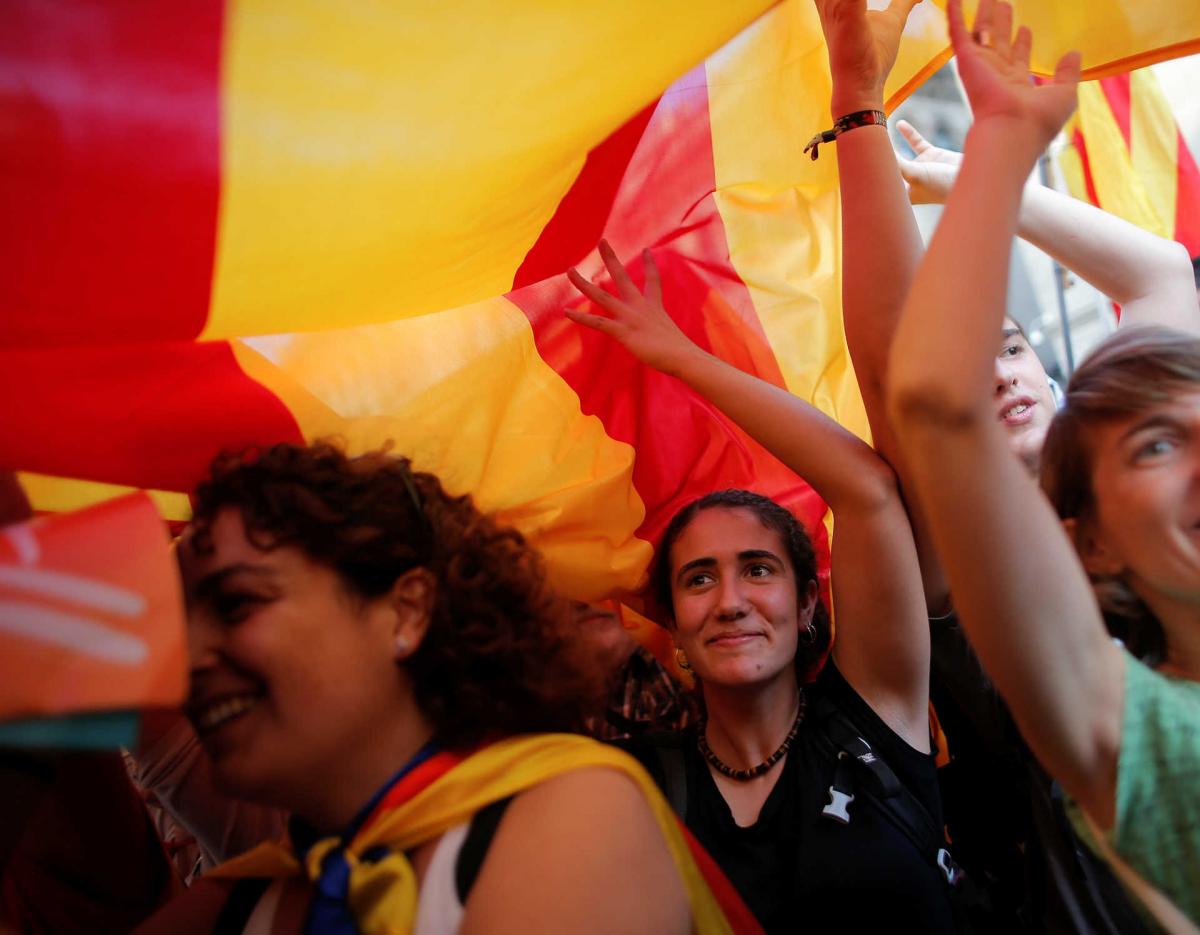 People celebrate in front of the Catalan regional government headquarters after the regional parliament declared independence from Spain in Barcelona